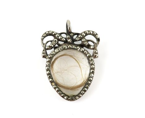 Georgian heart open locket, central rock crystal panel containing hair, surmounted by a marcasite set bow, 2.6 x 2cm, with a 