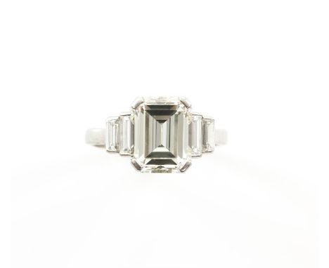 Large Emerald cut diamond ring, accompanied by a WGI diamond certificate stating the centre stone is estimated weight 4.66 ca