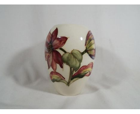 A Moorcroft pottery oviform vase with a floral pattern on a cream ground 11.5 cm (h) estimate £60 - £80