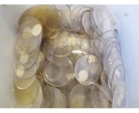A large quantity of pocket watch glasses of various sizes