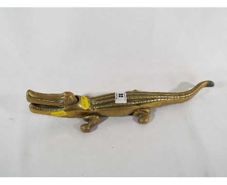 A heavy good quality brass crocodile nut cracker marked to the base with makers mark, 6cm (h) x 34cm (w)