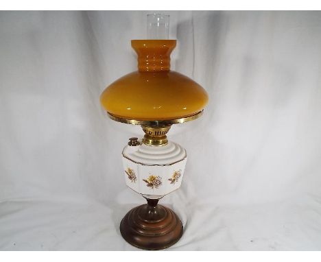 A ceramic oil lamp with glass funnel and reservoir, 57cm (h)