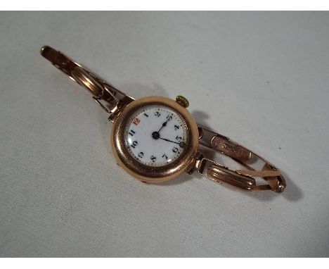A lady's 9 carat rose gold cased wristwatch on a 9 carat rose gold expanding bracelet, the case having London assay marks for