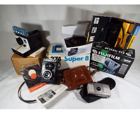 A good mixed lot of vintage cameras to include a Lubitel2, a Polaroid Land camera, a Fuji digital, a Francolor with manual an