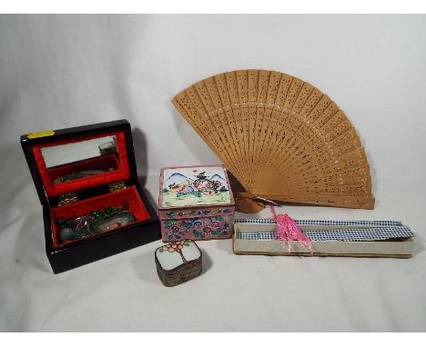 A collection of Chinese and Japanese boxes and stones to include a Chinese Famille Rose Cloisonne box and a Japanese black la