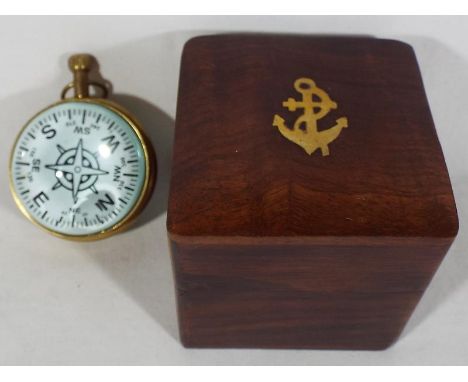 A good quality mahogany cased brass inlaid box containing a bulls eye clock depicting a ship, displayed on the fascia Superio