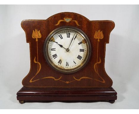 A mahogany and inlaid Art Nouveau style mantel clock, the enamel dial with Roman numerals fronting a French made cylinder esc