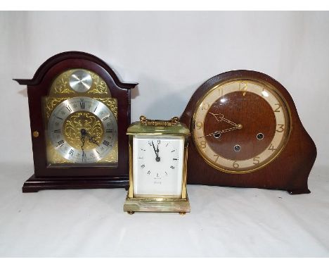 A Tempora onyx mantel clock, an oak cased mantel clock and a modern German Tempus Fuoil mantel (3) 