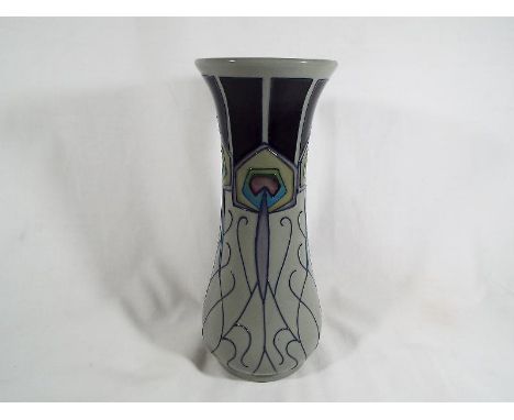 A Moorcroft pottery trumpet vase decorated in the Peacocks Parade pattern 21 cm (h) estimate £80 - £120