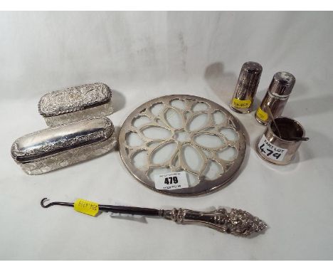 A George V silver and glass coaster, Birmingham assay 1929, an Elkington & Co silver plated cruet set, a silver handled butto