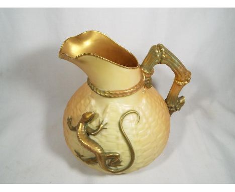 A Royal Worcester ewer / jug decorated with a depiction of a large gilded lizard on a blush ivory ground, 16cm (h) - Est £80 