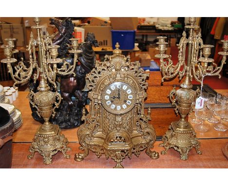 A French style brass cased mantel clock having enamel inset markers with Roman numerals having an 8 day movement with Green M