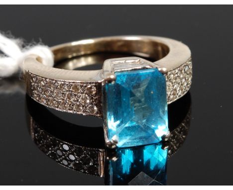 A 14ct gold blue topaz dress ring, the shoulders being pave set with small brilliant cut diamonds, 7g, size J