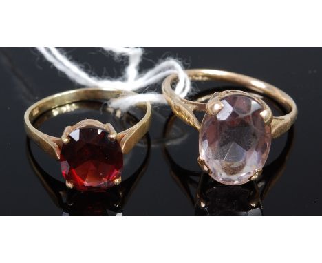 A 14ct gold and garnet set dress ring; together with a yellow metal and amethyst set dress ring (unmarked but tests as approx