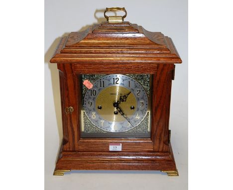 A modern oak cased bracket clock, the silvered dial with Arabic numerals and eight day movement, signed Howard Miller, within