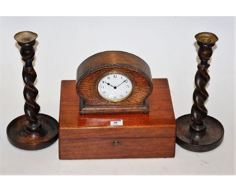 A 1930s oak cased mantel clock, having enamelled dial with Arabic numerals; together with a pair of 1920s beech spirally turn