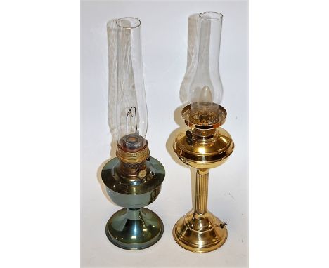 An early 20th century brass pedestal oil lamp (later converted for electricity); together with one other oil lamp (2) 