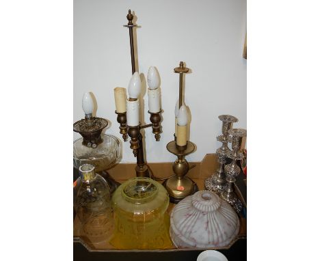A box of various lighting to include two table lamps, a converted oil lamp, pair of candlesticks, and various glass shades