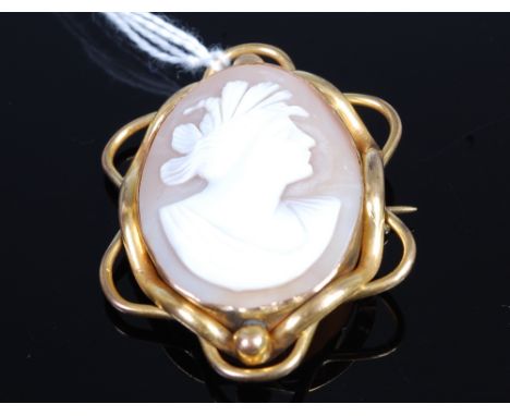 A carved shell cameo brooch depicting profile portrait of a maiden in pinchbeck mount