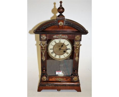 A late 19th century Continental faux walnut cased and brass mounted mantel clock, having enamelled dial with Roman numerals, 