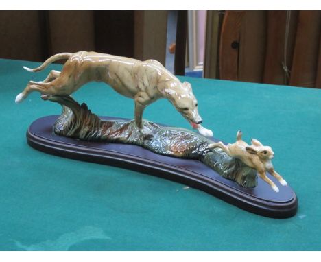 GLAZED CERAMIC FIGURE GROUP DEPICTING A HUNTING DOG CHASING A HARE, STAMPED ELITE 