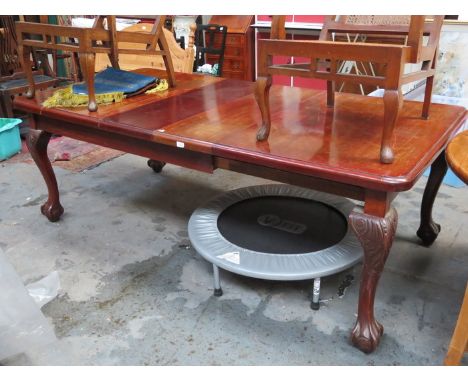 MAHOGANY EXTENDING DINING TABLE WITH TWO LEAVES ON CARVED BALL AND CLAW SUPPORTS 