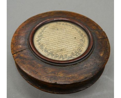 An early 19th century oak circular snuff box.  9 cm diameter.