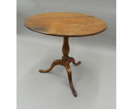 A 19th century oak and mahogany tripod table. 75 cm diameter.