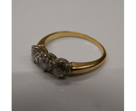 An unmarked gold three stone diamond ring. Ring size K (2.5 grammes total weight)