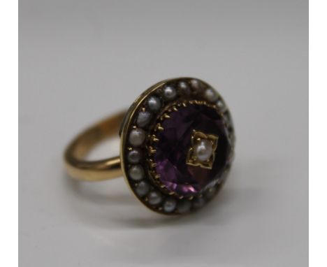 An unmarked gold, possibly 18 ct gold, pearl and amethyst elaborately worked circular form ring, the shank with interior insc