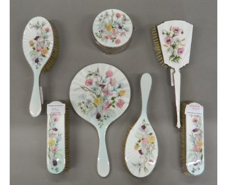 A silver and enamel dressing table set. Mirror 25.5 cm long.