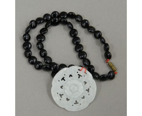 A Chinese jade pendant on necklace.  5 cm diameter.