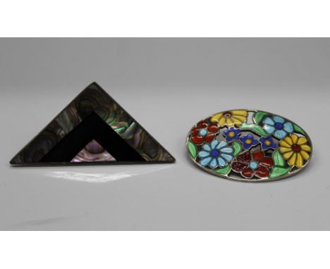 A vintage silver and enamel floral brooch, together with a Mexican silver abalone shell and onyx brooch. The former 4.5 cm wi