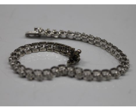 A 14 K white gold bracelet set with diamonds. 18.5 cm long (11 grammes total weight).