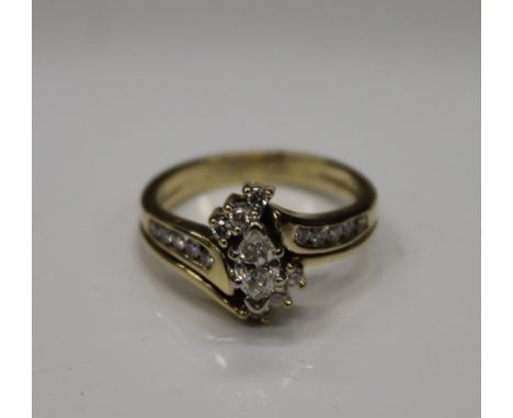 A 14 K  gold multi diamond ring, the central navette cut stone surrounded by sixteen smaller stones. Ring size M (4.5 grammes