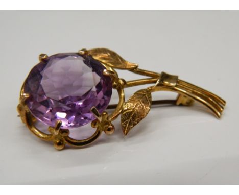 A 9 ct gold and amethyst brooch of floral form.  4.5 cm high (6.7 grammes total weight)