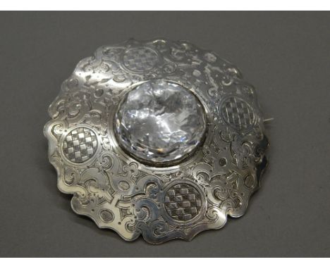 A large 19th century Scottish unmarked silver and rock crystal cloak badge.  8.5 cm diameter (59.1 grammes total weight)