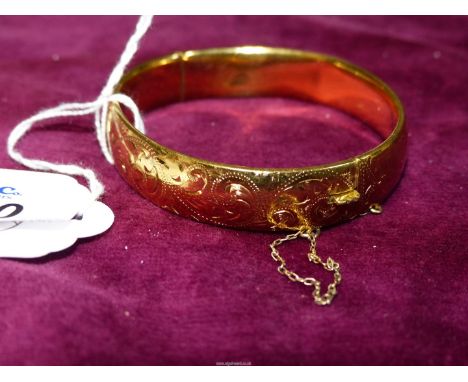 An attractive 9ct gold metal cored Bangle with safety chain. 20 micron.