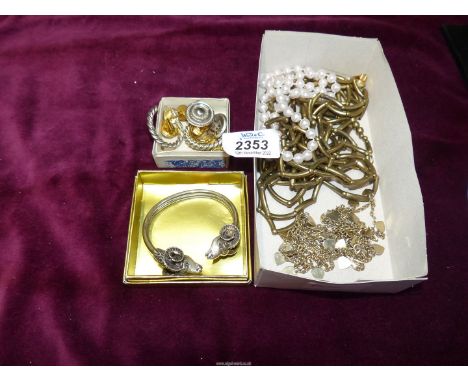 A quantity of costume jewellery including Ram's head bangle, clip on earrings, cufflinks etc.