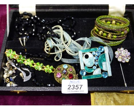 A small quantity of costume jewellery including enamelled pendant, black bead necklace, brooch, earrings etc.