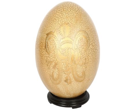An ornamental gilded ceramic egg on stand, H36cm 