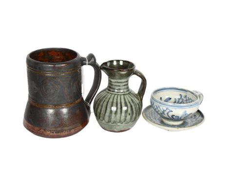 3 pieces of Studio pottery, Seth Cardew cup and saucer and a large Abuja pottery tankard, both with makers stamp and another 