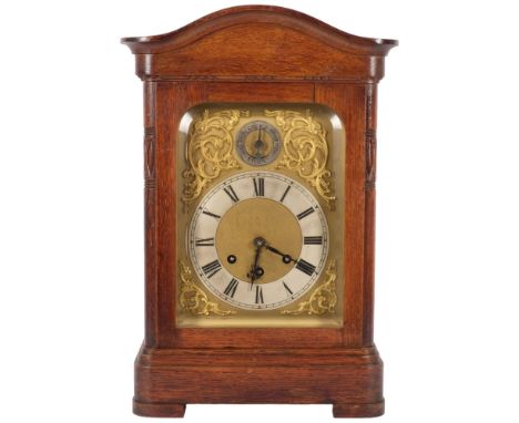 An oak-cased mantel clock, with brass dial and silvered chapter ring, and a Gustov Becker 8-day chiming movement, complete wi