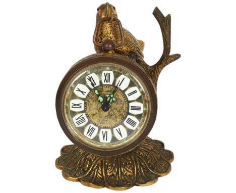 "Marksmen", a brass-cased travelling alarm clock, on a bird and branch stand, H11cm 