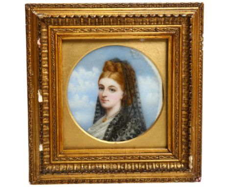 A 19th century circular miniature, watercolour on porcelain panel, portrait study of a young lady with a pearl and gold locke
