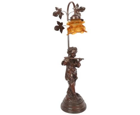 A composition table lamp supported by cherub musician, with amber glass shade, 65cm 