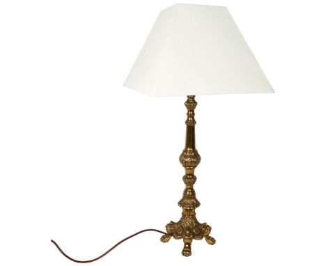 A decorative embossed brass table lamp and shade, height to top of bayonet fitting 58cm 