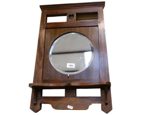 An Art Nouveau stained wood-framed wall mirror, with integral shelf, 57cm x 38cm 