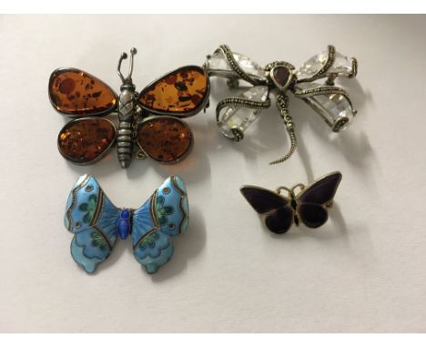 A collection of four Butterfly, dragonfly brooches , including enamel .