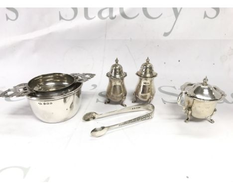 A Collection of silver items including a tea strainer a set of tongs and a condiment set. Total weight approx 205g